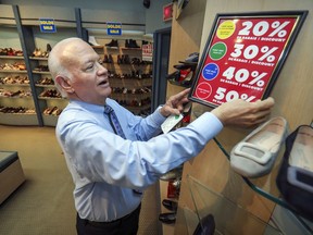 Tony Fargnoli sets up a sale sign in his Tony Shoes store on Monday June 22, 2020.