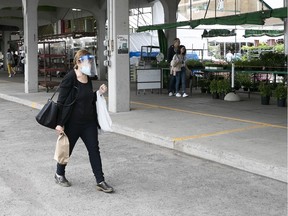 A shopper walks along the empty stalls of Jean-Talon market on Saturday June 27, 2020. (Pierre Obendrauf / MONTREAL GAZETTE) ORG XMIT: 64656- 0167