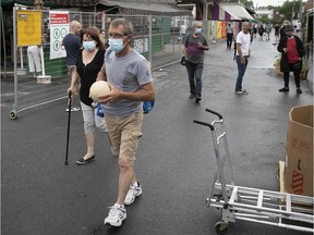 Few shoppers walk through the outdoor area of Jean-Talon market on Saturday June 27, 2020. (Pierre Obendrauf / MONTREAL GAZETTE) ORG XMIT: 64656- 0167