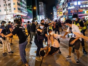 Undercover police arrested attendees during a memorial vigil in Mongkok on June 4, 2020 in Hong Kong, China. Thousands gathered for the annual memorial vigil in Victoria Park to mark the 1989 Tiananmen Square Massacre despite a police ban citing coronavirus social distancing restrictions.