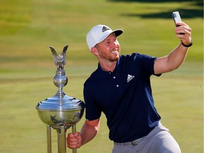 Daniel Berger of the United States takes a selfie as he celebrates with the Leonard Trophy after defeating Collin Morikawa of the United States in a playoff during the final round of the Charles Schwab Challenge on Sunday, June 14, 2020, at Colonial Country Club in Fort Worth, Tex.