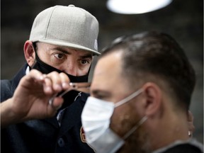 Barber Demo Pedulla cuts Ari Magden's hair as Bloke's Barber reopens in Montreal, on Monday, June 15, 2020.