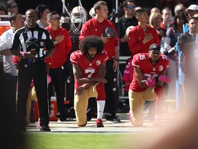 Eric Reid #35 and Colin Kaepernick #7 of the San Francisco 49ers kneel in protest during the national anthem prior to their NFL game against the Tampa Bay Buccaneers at Levi's Stadium on October 23, 2016 in Santa Clara, California.