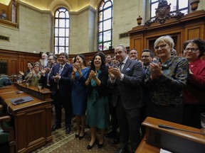 "On behalf of all the Asian communities in Montreal and myself and my future daughter, I thank you from the bottom of my heart," said council speaker Cathy Wong, centre left, pictured in 2019.
