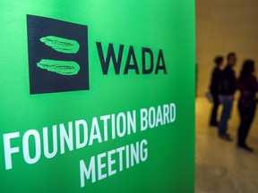 In this file photo, journalists stand in the lobby of the World Anti-Doping Agency (WADA) foundation board in Baku on Nov. 15, 2018. - An investigation into the International Weightlifting Federation found widespread corruption and dozens of covered-up drugs tests, officials said June 4, 2020. Lead investigator Richard McLaren said the probe into the IWF's affairs under former president Tamas Ajan uncovered millions of dollars in missing money and 40 doping cases that had been hushed up. McLaren's report accused Ajan of an "autocratic, authoritarian" leadership style that had resulted in "dysfunctional, ineffective" oversight of the sport's governing body.
