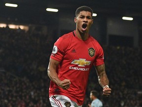 (FILES) In this file photo taken on December 01, 2019 Manchester United's English striker Marcus Rashford celebrates scoring their first goal (later given as an own-goal against Aston Villa's English goalkeeper Tom Heaton)  during the English Premier League football match between Manchester United and Aston Villa at Old Trafford in Manchester, north west England, on December 1, 2019. - Rashford has pleaded with the British government to continue to supply free meals for children in poorer families during the summer holidays in a letter "written from the heart". (Photo by Oli SCARFF / AFP) / RESTRICTED TO EDITORIAL USE. No use with unauthorized audio, video, data, fixture lists, club/league logos or 'live' services. Online in-match use limited to 120 images. An additional 40 images may be used in extra time. No video emulation. Social media in-match use limited to 120 images. An additional 40 images may be used in extra time. No use in betting publications, games or single club/league/player publications. /