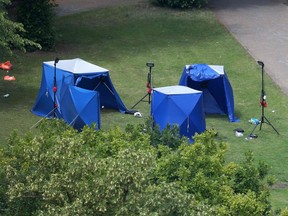A picture shows police tents and equipment at the scene of a fatal stabbing incident that is being treated as terrorism in Forbury Gardens park in Reading, west of London, on June 21, 2020. - British police said Sunday they were treating a stabbing spree in which a lone assailant killed three people in a park filled with families and friends in the southern English city of Reading as a "terrorism incident". (Photo by - / AFP)