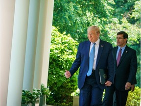 In this file photo taken on May 15, 2020 US President Donald Trump walks with Defense Secretary Mark Esper through the Colonnades on his way to speak on vaccine development in the Rose Garden of the White House in Washington, DC. - Defense Secretary Mark Esper will present President Donald Trump with a series of options on June 29, 2020 to withdraw thousands of US troops from Germany, with many moving to eastern Europe, the Pentagon said Saturday. (Photo by MANDEL NGAN / AFP)