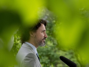 Prime Minister Justin Trudeau listens to a question from a reporter during a news conference outside Rideau cottage in Ottawa, Thursday June 4, 2020.