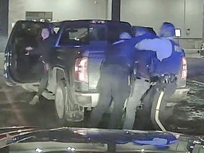 Dash-cam footage from a Wood Buffalo RCMP vehicle shows a police officer, left, tackling Chief Allan Adam to the ground during an arrest March 10, 2020 outside the Boomtown Casino in downtown Fort McMurray.