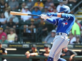 Toronto Blue Jays shortstop Bo Bichette (11) hits a home run during the fifth inning against the Pittsburgh Pirates at LECOM Park on Marsh 12, 2020.