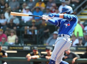Toronto Blue Jays shortstop Bo Bichette (11) hits a home run during the fifth inning against the Pittsburgh Pirates at LECOM Park on Marsh 12, 2020.