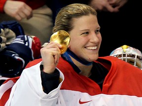 Team Canada goalie Kim St. Pierre shows off her gold medal following victory over the United States at the 2010 Olympic Games in Vancouver.