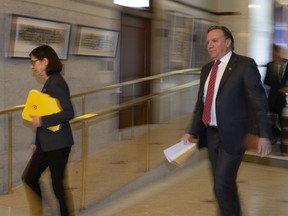 Quebec Health Minister Danielle McCann, left, and Quebec Premier Francois Legault walk to a news conference on the COVID-19 pandemic, Tuesday, April 14, 2020