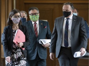 Quebec Premier François Legault, right, then-Health Minister Danielle McCann, left, and Horacio Arruda, Quebec director of National Public Health, centre, walk to a news conference on the COVID-19 pandemic, Wednesday, May 27, 2020 at the legislature in Quebec City.