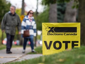 People arrive at a polling station in Mississauga, Ont., to vote in the federal Canadian election on Oct. 21, 2019.