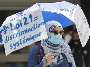 People protest against Law 21 outside Quebec Premier Francois Legault's office in Montreal, Sunday, June 14, 2020, on the one year year anniversary of the controversial bill. The COVID-19 pandemic continues in Canada and around the world.