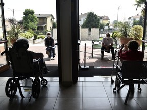 Residents of a nursing home speak to relatives sitting outside and keeping a safe distance, as the spread of the coronavirus disease (COVID-19) continues in Capralba, near Cremona, Italy May 22, 2020. Picture taken May 22, 2020. REUTERS/Flavio Lo Scalzo