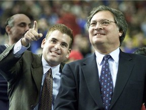 Expos majority owner Jeffrey Loria (right) and stepson David Samson watch video highlights during ceremonies before 2001 home opener against the New York Mets at Olympic Stadium in Montreal.