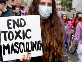 A demonstrator holds a sign during a march to demand more equality and the end of violence against women, amid the coronavirus disease (COVID-19) outbreak, in Zurich, Switzerland, on Sunday, June 14, 2020.