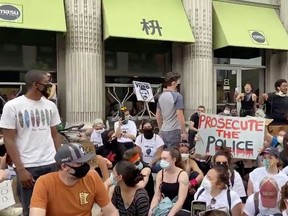 Minneapolis Mayor Jacob Frey walks through a crowd of jeering protesters, in the aftermath of the death in Minneapolis police custody of George Floyd, in Minneapolis, Minnesota June 6, 2020, in this still image obtained from a social media video. Courtesy of CTUL/Social Media