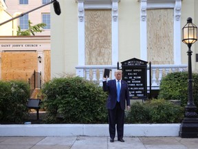 U.S. President Donald Trump holds up a Bible as he stands in front of St. John's Episcopal Church across from the White House after walking there for a photo opportunity amidst ongoing protests over racial inequality in the wake of the death of George Floyd while in Minneapolis police custody, near the White House in Washington, U.S., June 1, 2020.