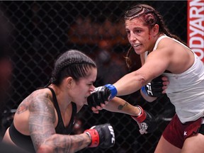 June 6, 2020; Las Vegas, NV, USA; Felicia Spencer of Canada punches Amanda Nunes of Brazil in their UFC featherweight championship bout during UFC 250 at the UFC APEX.  Mandatory Credit: Jeff Bottari/Zuffa LLC via USA TODAY Sports