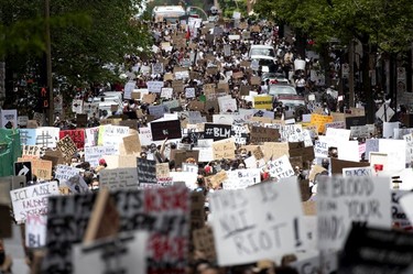 Thousands of people stream down Bleury St. as they take part in march against racism and police brutality in Montreal on Sunday, June 7, 2020.