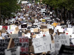 Thousands of people stream down Bleury St. as they take part in march against racism and police brutality in Montreal on Sunday, June 7, 2020.