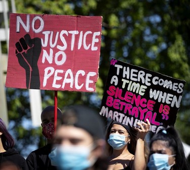 Signs of the times at march against racism and police brutality in Montreal on Sunday, June 7, 2020.