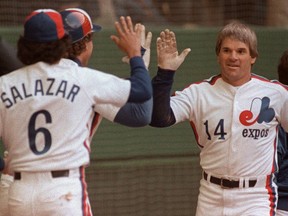 Montreal Expo's Pete Rose is congratulated by teammates Gary Carter and Argenis Salazar following Rose's 4,000th career hit during the Expos' home opener on April 13, 1984.