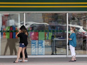 Customers observe social-distancing guidelines outside the Dollarama in the Southdale Shopping Centre on Lakewood Blvd. in Winnipeg is pictured on May 19, 2020.