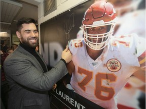 Laurent Duvernay-Tardif is all smiles after signing banner of himself, which was unveiled at the McGill sports centre on Feb. 12, 2020.