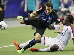 Montreal Impact midfielder Bojan trips over Deportivo Saprissa's Aubrey David during second half of the CONCACAF Champions League game at Olympic Stadium in February.