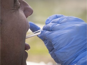 A Montrealer gets a COVID-19 test at a mobile clinic in May 2020.