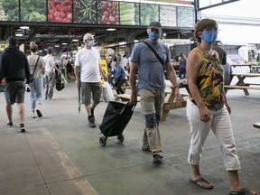 These shoppers at Jean-Talon Market on Saturday are wearing face masks, something that Fariha Naqvi-Mohamed should be mandatory in Montreal.