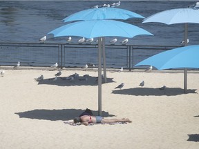 MONTREAL, QUE.: JULY 6, 2020 --  A woman takes in the sun on the deserted beach at the Old Port on Monday July 6, 2020. The beach was reopened last Friday. (Pierre Obendrauf / MONTREAL GAZETTE) ORG XMIT: 64686- 1113