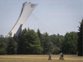 Kids use their bikes on the yellow grass fields of Maisonneuve park on Tuesday July 7, 2020. The city is going through its fourth heat wave of the season. (Pierre Obendrauf / MONTREAL GAZETTE)