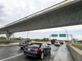 Cars on St. Charles Blvd. in Kirkland pass under a completed section of the REM train span.