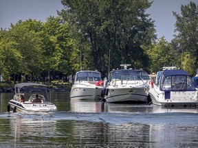 A boat leaves its berth at the marina in Lachine July 9, 2020.