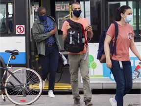 People disembark a bus at the Vendôme métro station in Montreal on July 13, 2020. Masks become mandatory on public transit in Quebec on Monday morning to stop the spread of COVID-19.