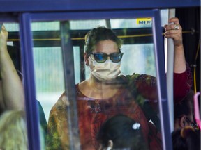 Maddalena Rainone stands on a bus at the Vendôme Metro station in Montreal Monday, July 13, 2020. Masks become mandatory on public transit in Quebec on Monday morning to stop the spread of COVID-19.