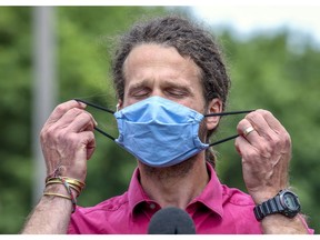 Dr. David Kaiser of Montreal’s public health department's takes off his mask before giving an update on the COVID-19 situation in bars at a news conference on July 14.