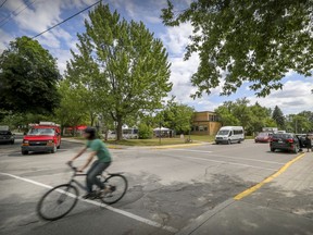 A cyclist rides through the intersection of Terrebonne St. and Benny St. in Montreal Tuesday July 14, 2020.  The NDG borough intends to put a bike path on the street running in front of St. Monica's School. (John Mahoney / MONTREAL GAZETTE)