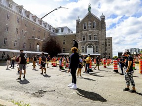 The line snakes through the Hôtel-Dieu site's parking lot for COVID-19 testing on July 15. Association for Canadian Studies president Jack Jedwab noted testing in Quebec has increased dramatically, which is partly responsible for the rise in cases.