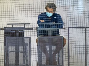 Canadiens GM Marc Bergevin wears a mask while watching team practice during training camp at the Bell Sports Complex in Brossard on Wednesday.