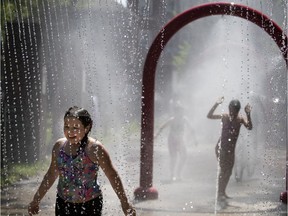 MONTREAL, QUE.: May 27, 2020 -- Katerina Manolopoulos runs through the splash pad installations at Parc de Lestre during an early heat wave in Montreal, on Wednesday, May 27, 2020. (Allen McInnis / MONTREAL GAZETTE) ORG XMIT: 64485