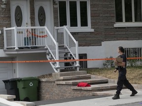 A police officer at the scene of stabbing where a 6 year-old girl was killed July 23, 2020 on Desautels Ave. in Montreal.