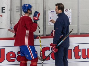 Canadiens defenceman Brett Kulakgets instructions from assistant coach Luke Richardson during practice Thursday at the Bell Sports Complex in Brossard.