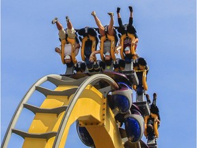 Masked people take a ride called the Vampire at La Ronde in Montreal on Saturday, July 25, 2020.